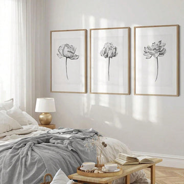 Enhance your space with this elegant black and white floral canvas art set. Add a touch of boho minimalism to any room with these beautiful pieces. Their frameless design allows for easy placement and versatile styling options. Elevate your wall decor game with a sophisticated touch.