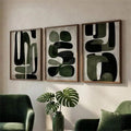 Olive abstract triptych above green chairs with a monstera vase