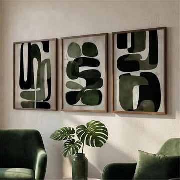 Olive abstract triptych above green chairs with a monstera vase