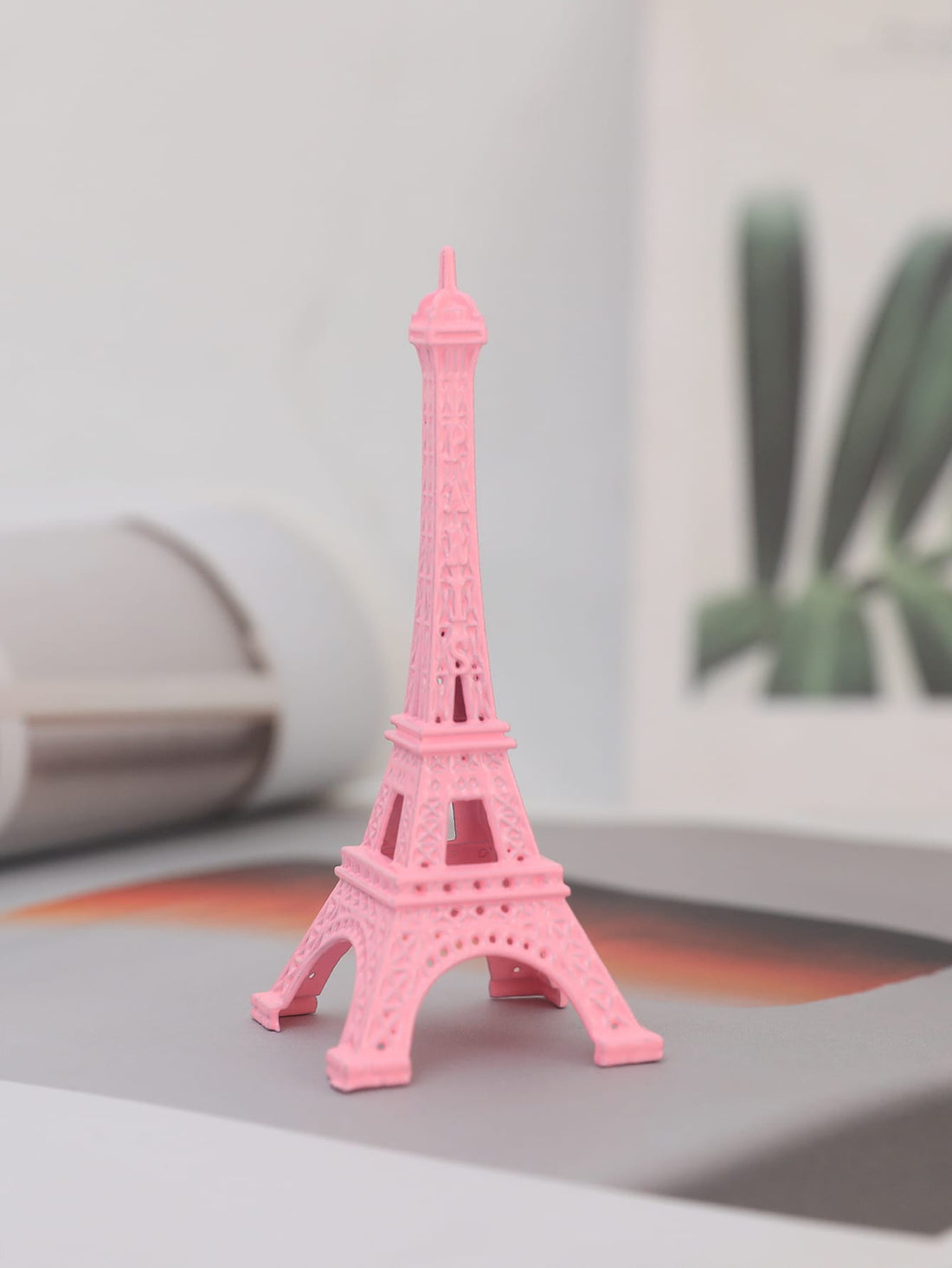 Experience the charm of Paris with our Parisian Charm decorative object. Made of high-quality pink zinc alloy, this Eiffel Tower replica will add a touch of elegance to your home decor. Bring the beauty and sophistication of the City of Light into your home today.