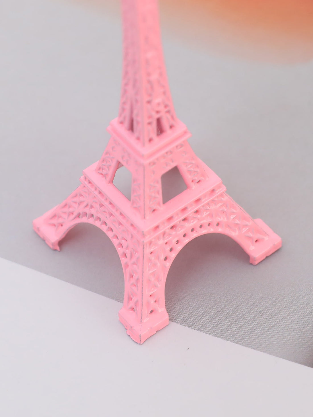 Experience the charm of Paris with our Parisian Charm decorative object. Made of high-quality pink zinc alloy, this Eiffel Tower replica will add a touch of elegance to your home decor. Bring the beauty and sophistication of the City of Light into your home today.