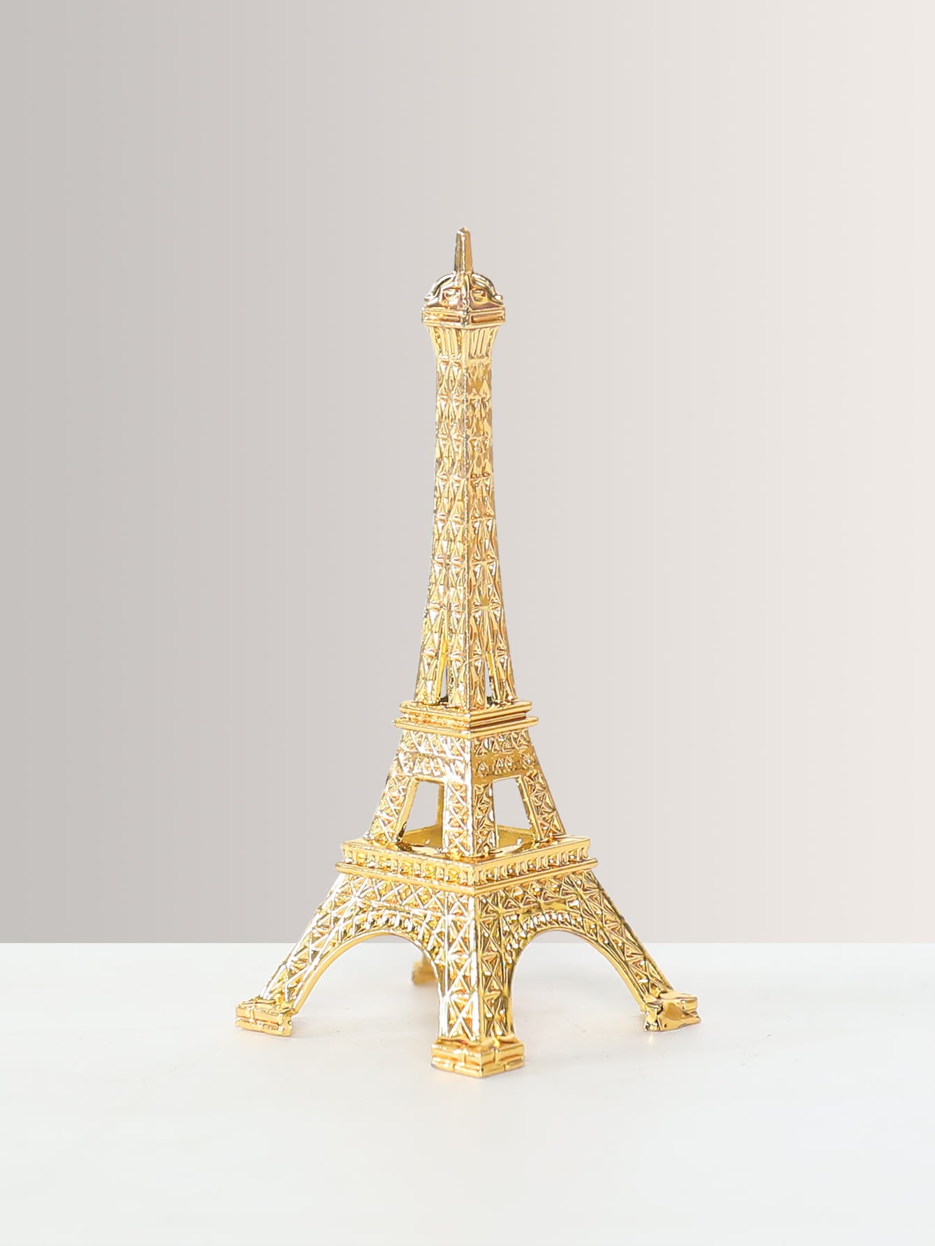 Expertly crafted, this Metal Eiffel Tower Decoration adds a touch of sophistication to any home or office space. Made of high-quality metal, it is a stylish accent that showcases your refined taste. Perfect as a gift or for personal use, it elevates any room with its elegant and timeless design.