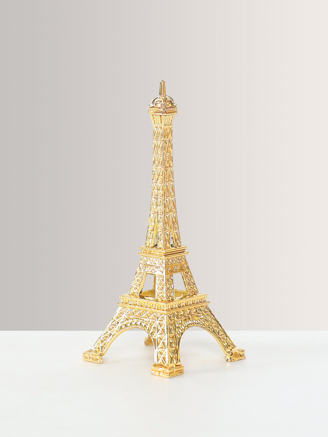 Expertly crafted, this Metal Eiffel Tower Decoration adds a touch of sophistication to any home or office space. Made of high-quality metal, it is a stylish accent that showcases your refined taste. Perfect as a gift or for personal use, it elevates any room with its elegant and timeless design.