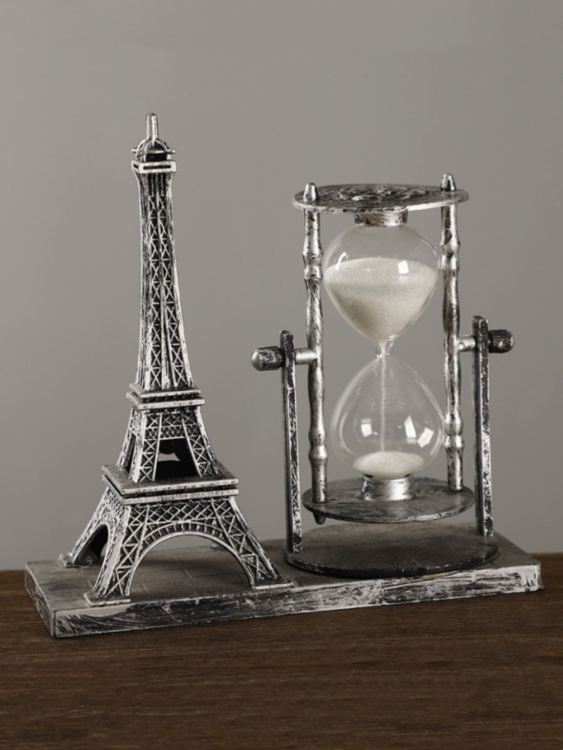 Elevate your home decor with this elegant Artistic Timepiece: Hourglass Tower. Crafted with intricate detailing, this table decor piece adds a touch of sophistication to any room. Use it as a functional timepiece or as a unique decor item to impress your guests. Made with quality materials, it's a perfect addition to your home.