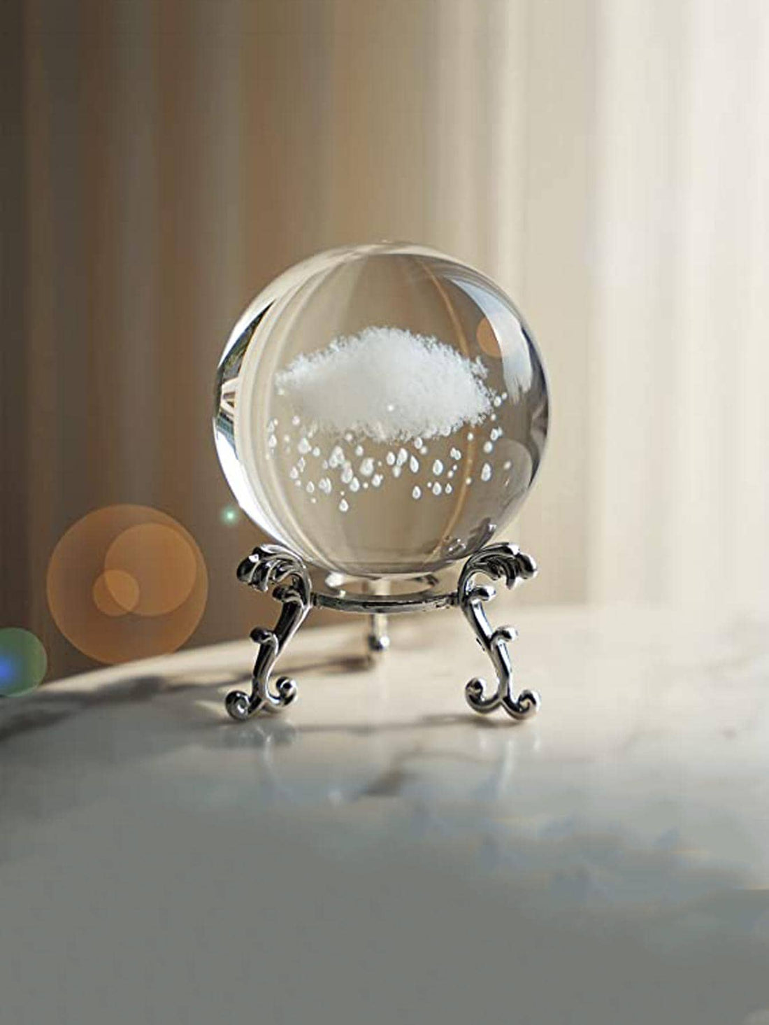 Expertly crafted with modern glass, this Crystal Ball Cloud Design adds a touch of elegance to any home. Its unique design offers a mesmerizing display, perfect for any decor style. Transform your living space with this stunning decoration.