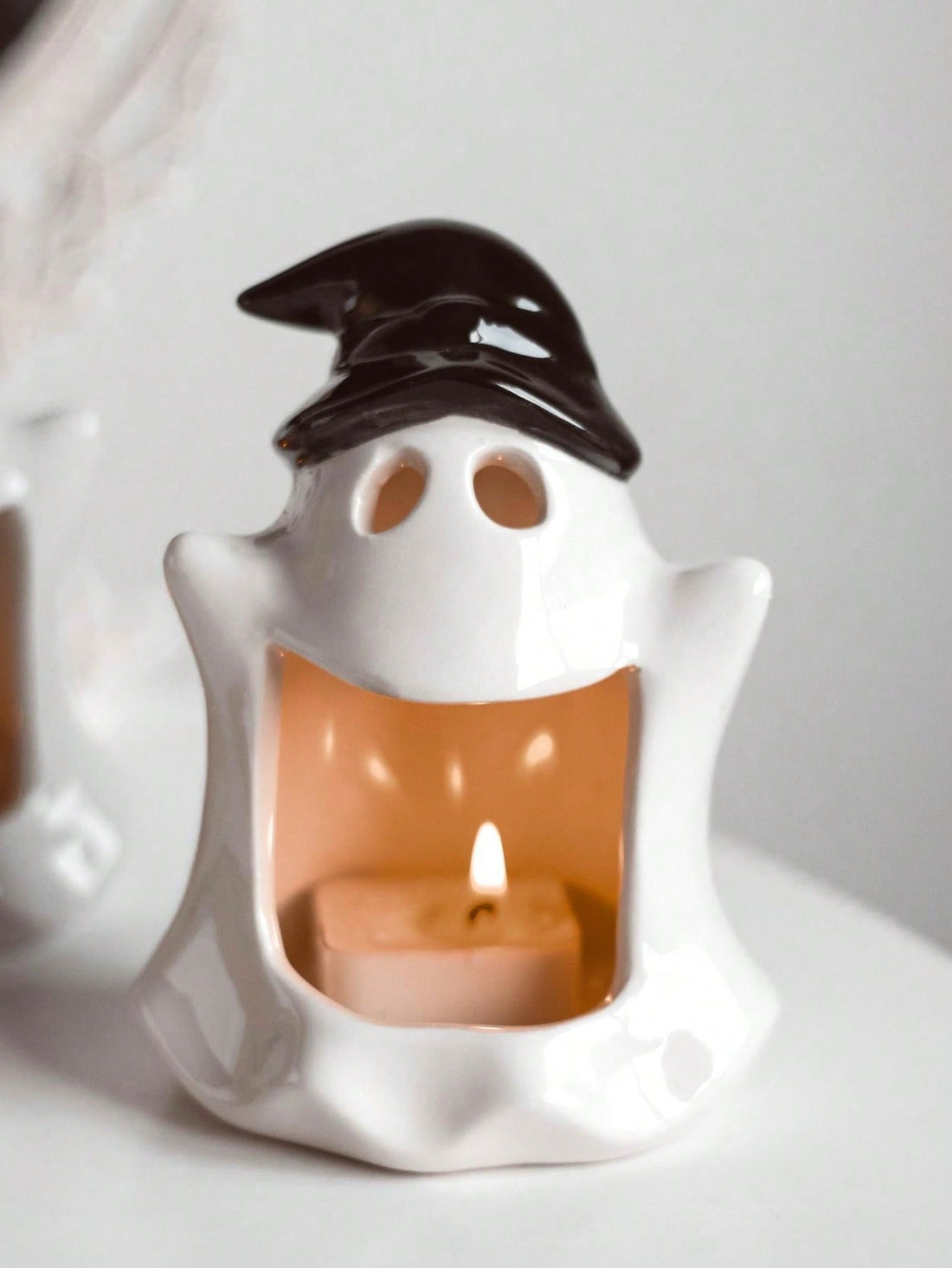 Add a touch of ghoulish charm to your wedding or festival with our Ceramic Ghost Candlestick. Made with exquisite craftsmanship, this piece serves as a charming decoration while providing a subtle source of light. Its unique design and quality materials make it the perfect addition to any spooky event.