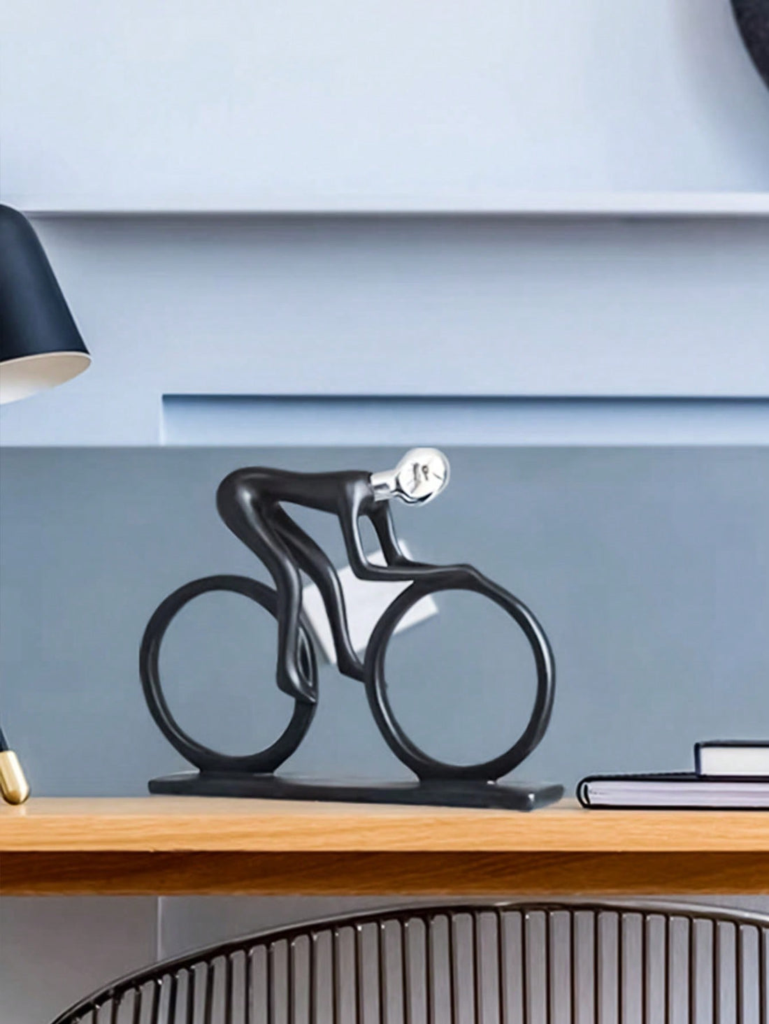 Enhance your home decor with this modern, minimalist ornament featuring a figure riding a bicycle. Perfect for table decor, this piece adds a unique touch to any room. Made with expert craftsmanship, this home decor ornament is a must-have for any modern and stylish space.