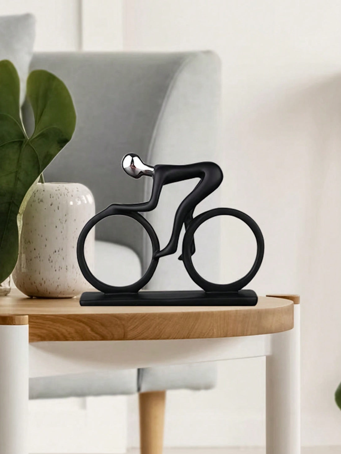 Enhance your home decor with this modern, minimalist ornament featuring a figure riding a bicycle. Perfect for table decor, this piece adds a unique touch to any room. Made with expert craftsmanship, this home decor ornament is a must-have for any modern and stylish space.