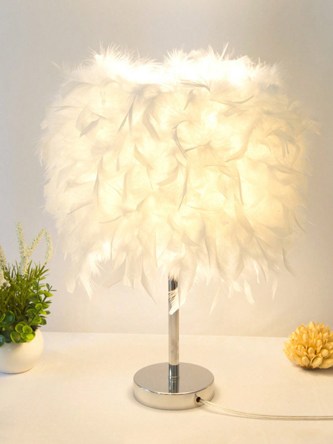 Enhance the ambiance of your bedroom with our European Elegance Feather Table Lamp. Featuring delicate feathers and a sophisticated design, this lamp adds a touch of romance to any space. Create a cozy and intimate atmosphere for a peaceful night's sleep.