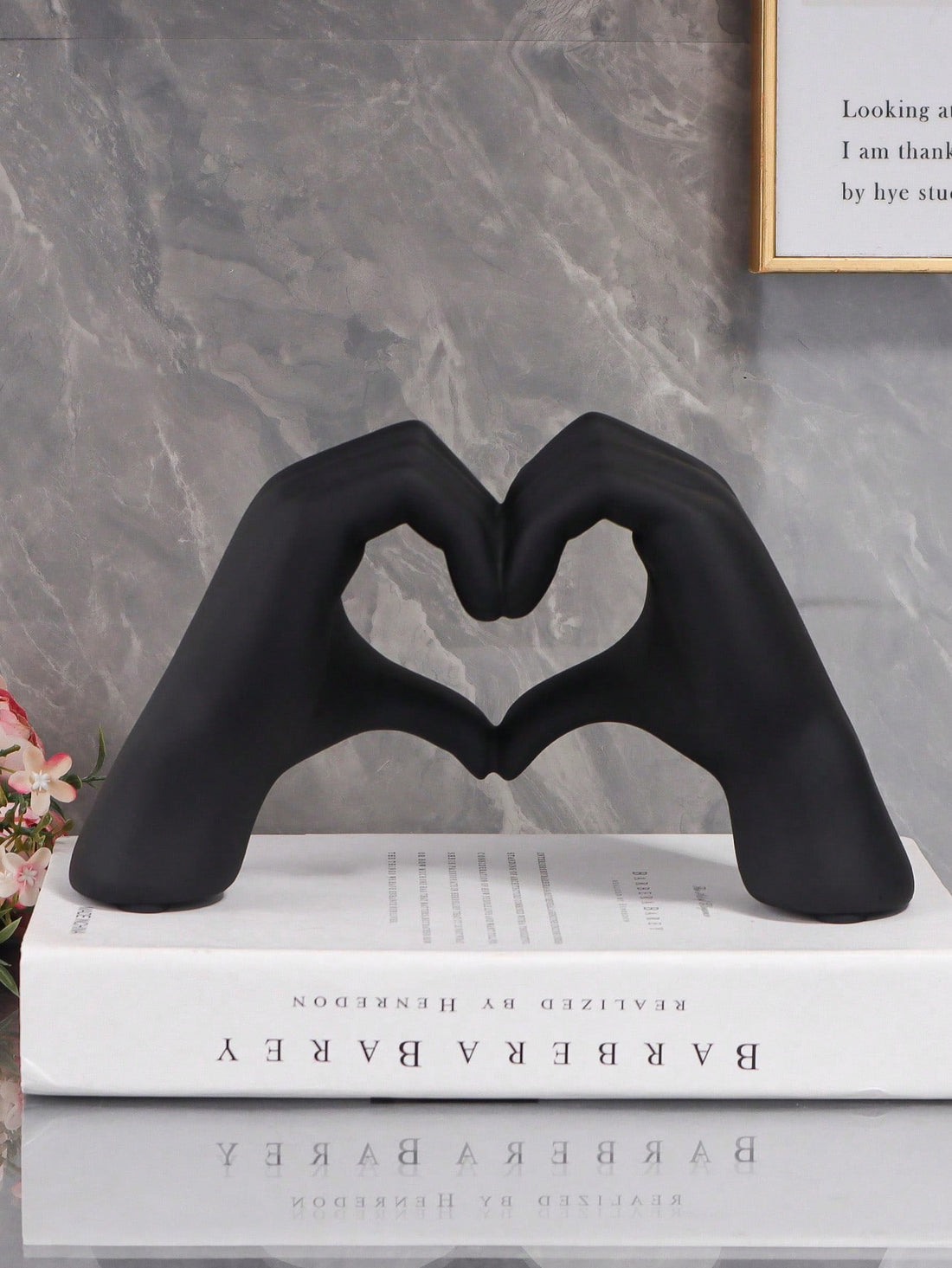 Indulge in elegant home decor with the Black Heart Hand Shaped Ornament. Made for chic taste, this ornament showcases a black heart hand crafted with care. Enhance your home's aesthetic with this stunning and unique addition.