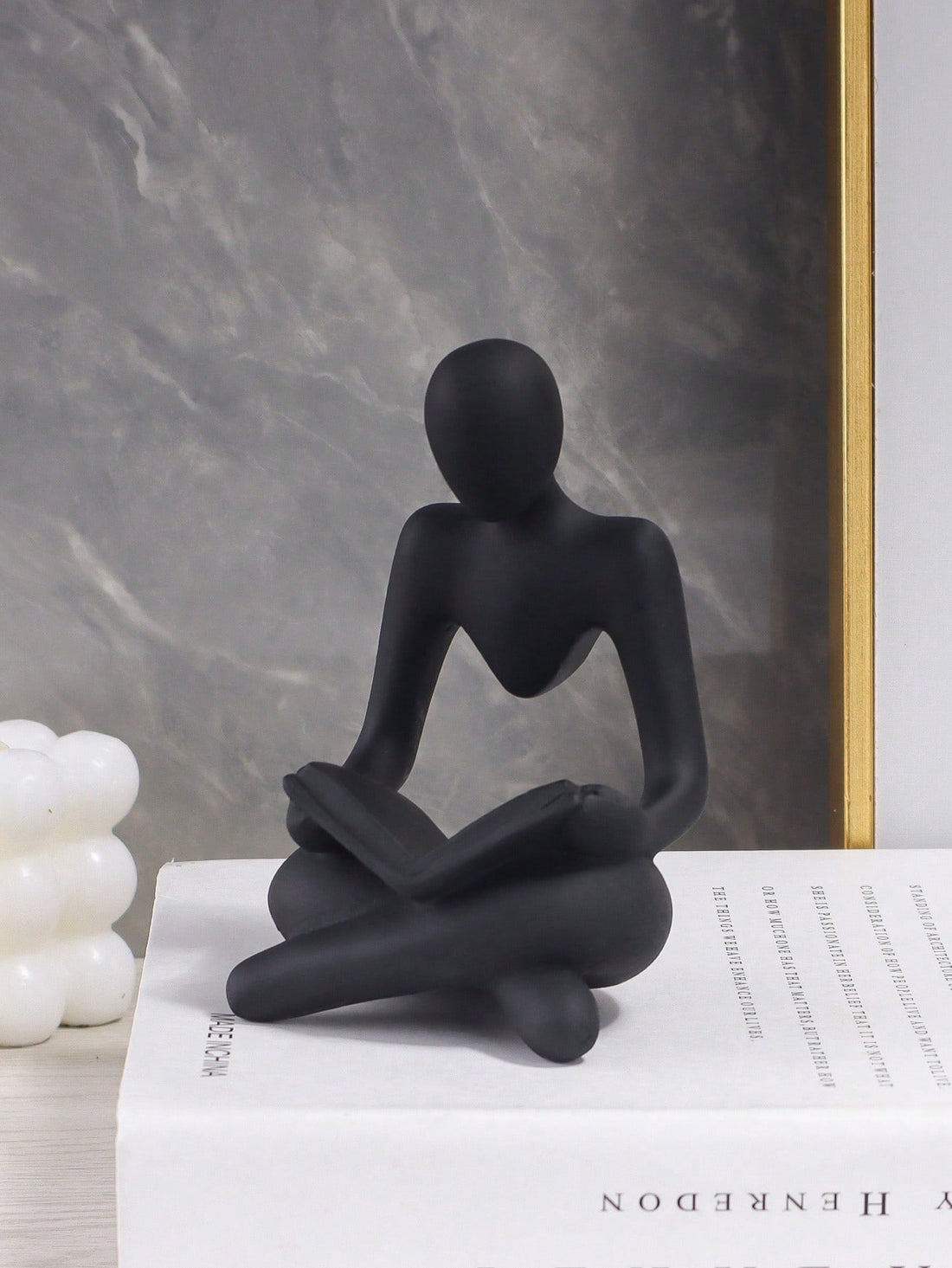 Enhance your home decor with our Black Resin Reading Figurine - a stylish and sophisticated addition to any table or shelf. This intricately designed piece adds a touch of elegance to any room and serves as a reminder to take time for yourself and curl up with a good book.