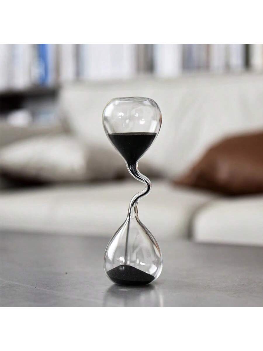 Upgrade your home or office decor with our sleek and stylish black glass sand timer. The modern design not only adds a touch of elegance, but also serves as a functional desktop accessory. Keep track of time in a sophisticated way with this unique piece.