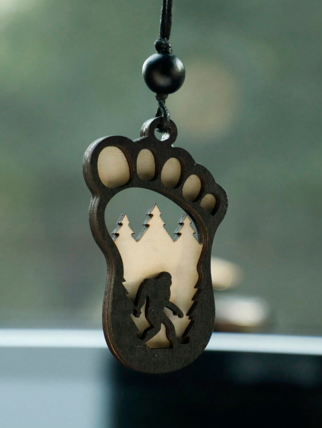 Introduce a little whimsy to your holiday decorations with this Wooden Bigfoot Christmas Ornament. The perfect gag gift for Yeti lovers, this ornament will add a touch of mystery and fun to any tree. Crafted from durable wood, it features a hanging design for easy display. Add a touch of humor to your seasonal decor with this charming ornament.