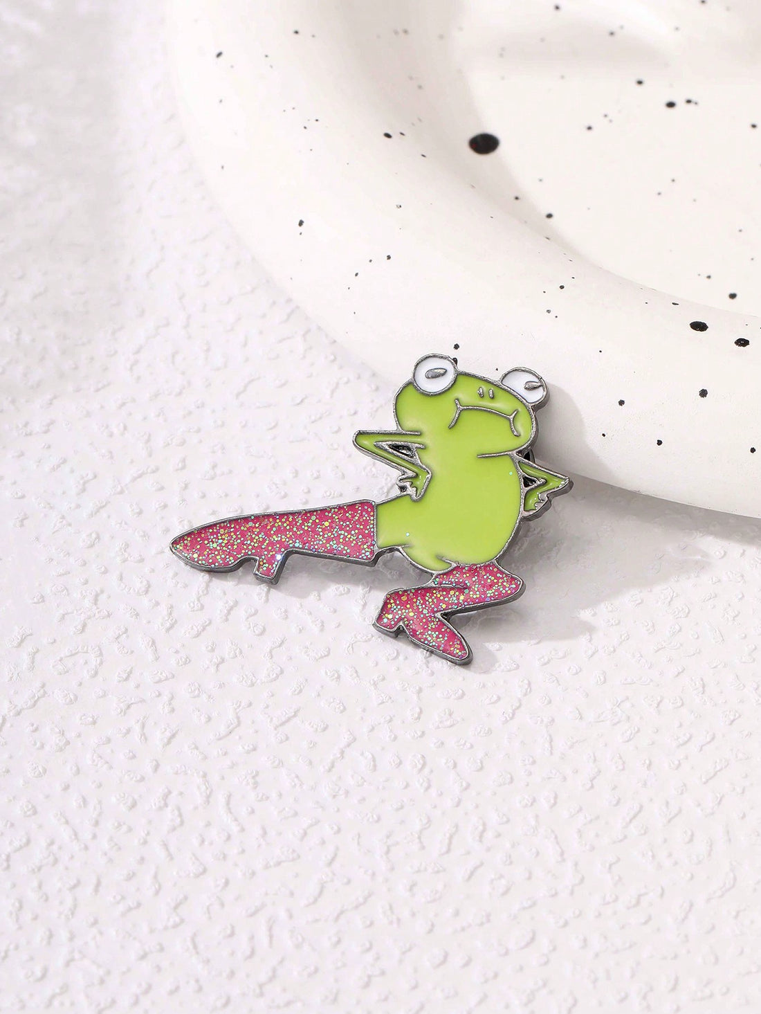 Celebrate your love for fashion and cute critters with Froggy Fashion's Cartoon High Heel Brooch. This delicate and charming accessory showcases a playful frog sitting atop a fashionable high heel shoe. Perfect as a gift for any fashionista or animal lover, this brooch will add a touch of whimsy to any outfit.