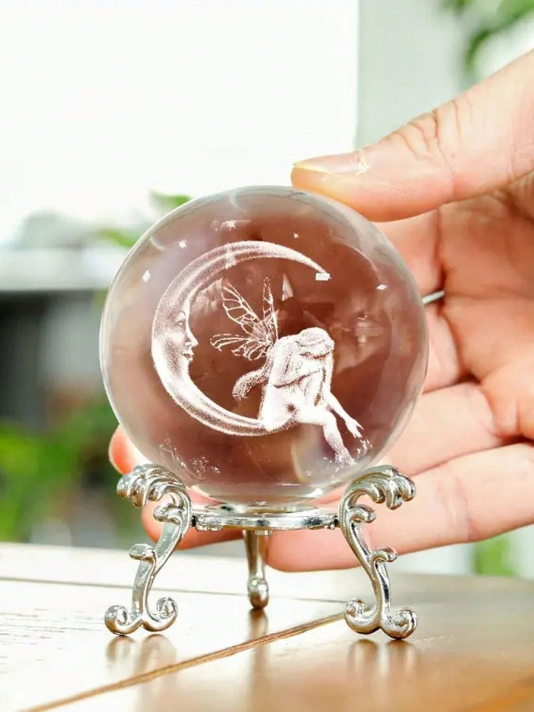 Add a touch of magic to your home with our Moon Fairy Crystal Ball. This stunning glass planet decor is not only a beautiful addition to your table, but also a unique and creative way to bring the enchantment of the moon into your living space. Expertly crafted, this crystal ball is perfect for any fairy or fantasy lover.