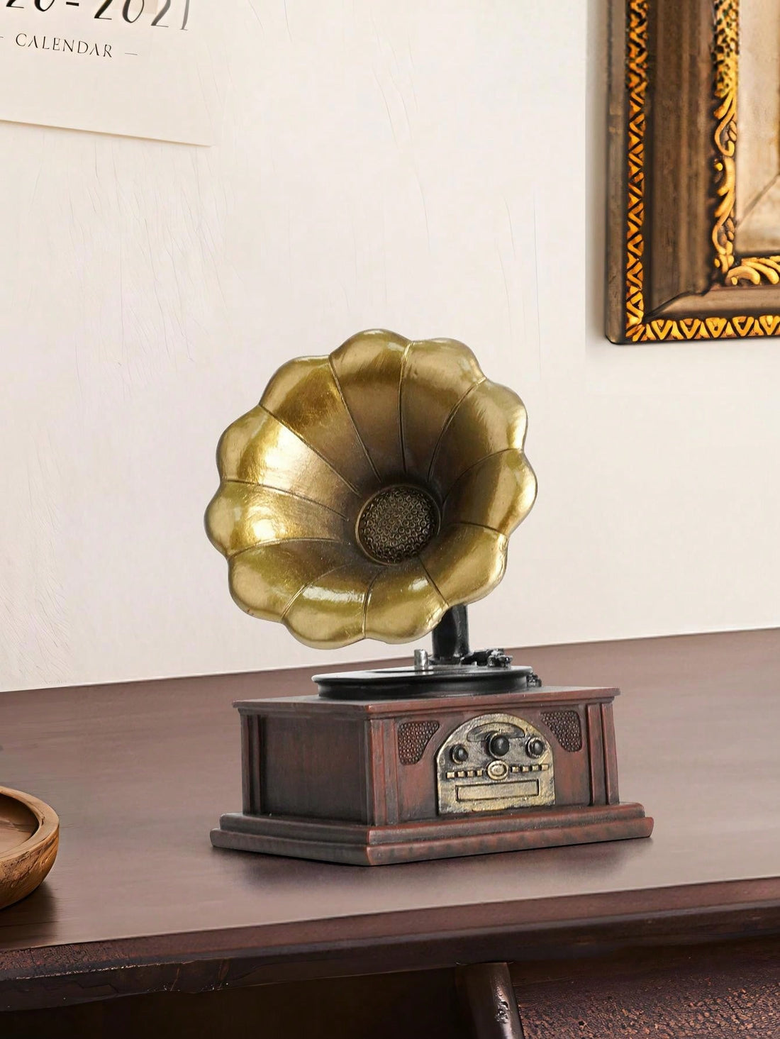 Enhance your home decor and surprise your loved ones with this Vintage Charm Phonograph Figurine. Crafted with resin, this timeless piece adds a vintage touch to any room. Perfect for music enthusiasts and collectors, this figurine makes a unique gift option.