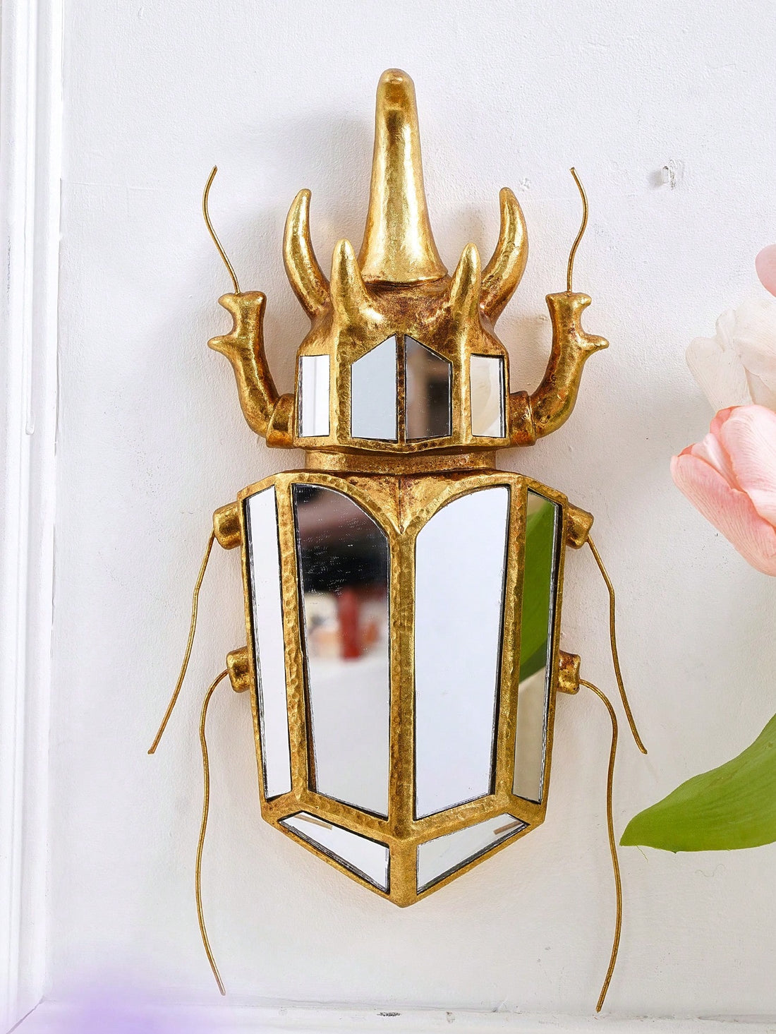 This Mirrored Rhino Beetle Wall Decor is a must-have for insect lovers. Its unique design and expert craftsmanship will make it a standout piece in any room. With its mirrored finish, this collectible will add a touch of elegance and intrigue to your home.