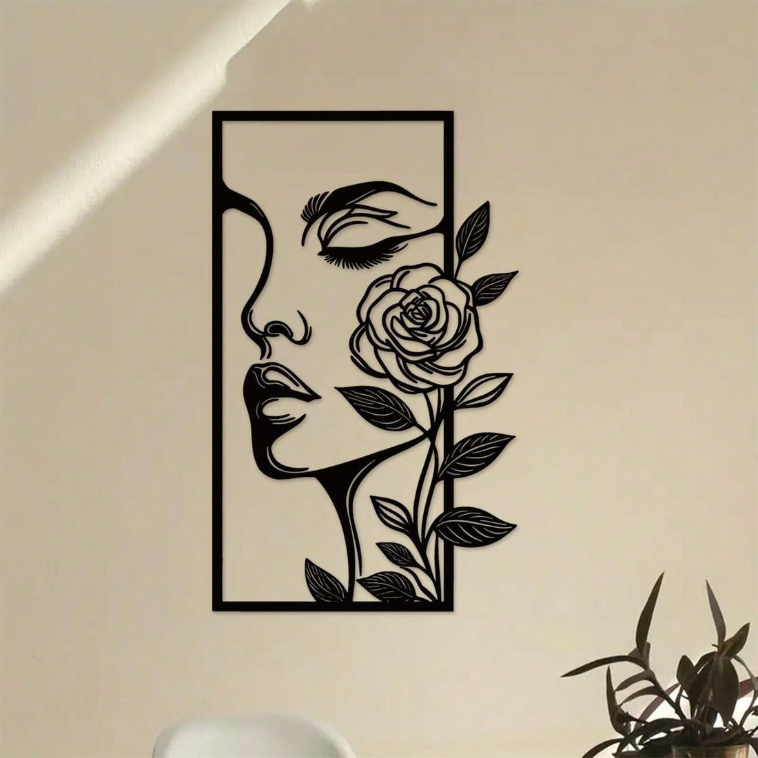 Add a touch of elegance and beauty to your home with Floral Femme Fatale metal wall decor. Featuring a woman's face and delicate flower outline, this ornament exudes an aesthetic charm. Crafted with high-quality metal, it is durable and adds a unique touch to any room.