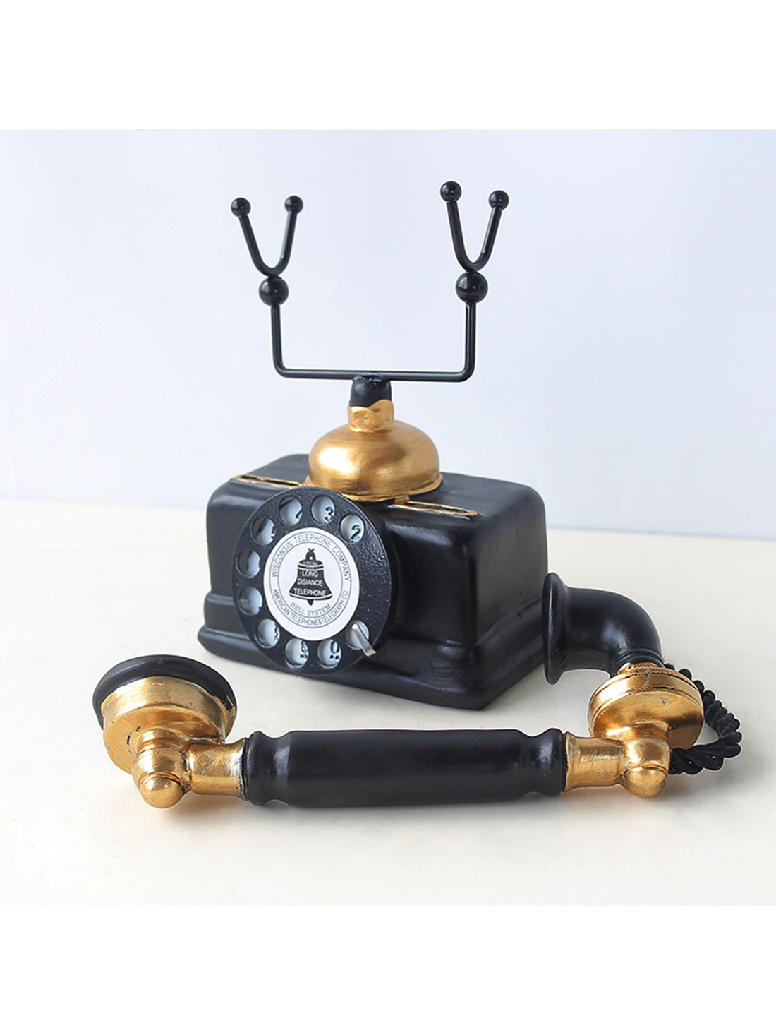 This vintage resin telephone model is a perfect timeless desk ornament for home decor. With its intricate details and classic design, it adds a touch of nostalgia to any room. Made from high-quality materials, it is a durable and stylish choice for any decor style.