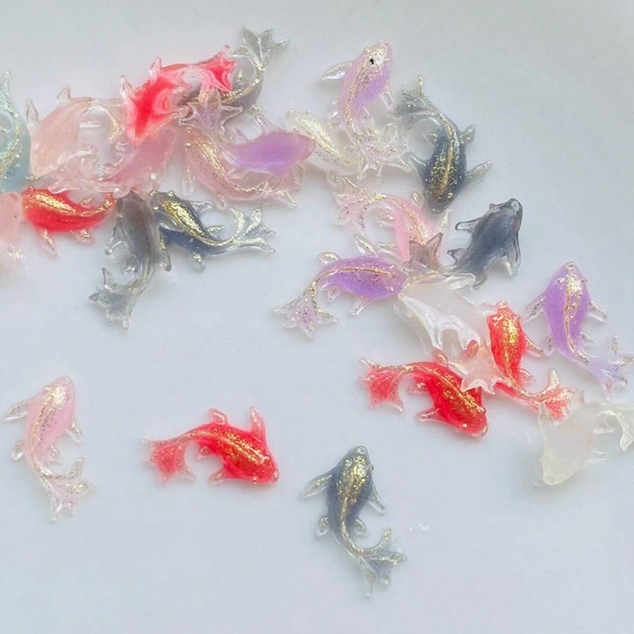 Add a touch of cuteness to your crafts and jewelry with our Adorable Mini Shiny Goldfish Resin Figurines! With 100 pieces per pack, you'll have plenty to work with. Made from high-quality resin, these figurines are perfect for adding a unique and eye-catching element to your creative projects.