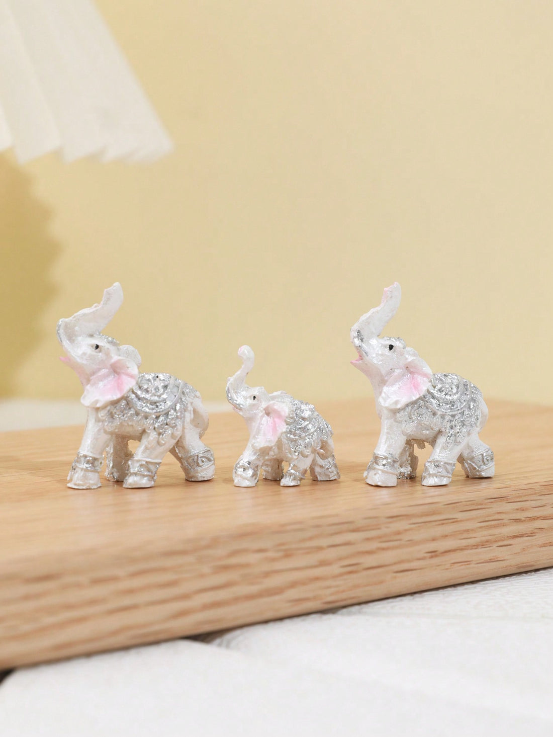 This Elegant Elephant Trio is a stunning addition to any home decor. Made of high-quality resin, these intricately crafted elephant figurines are a symbol of love and family. Perfect as table ornaments, these elegant elephants will add a touch of sophistication to your living space.