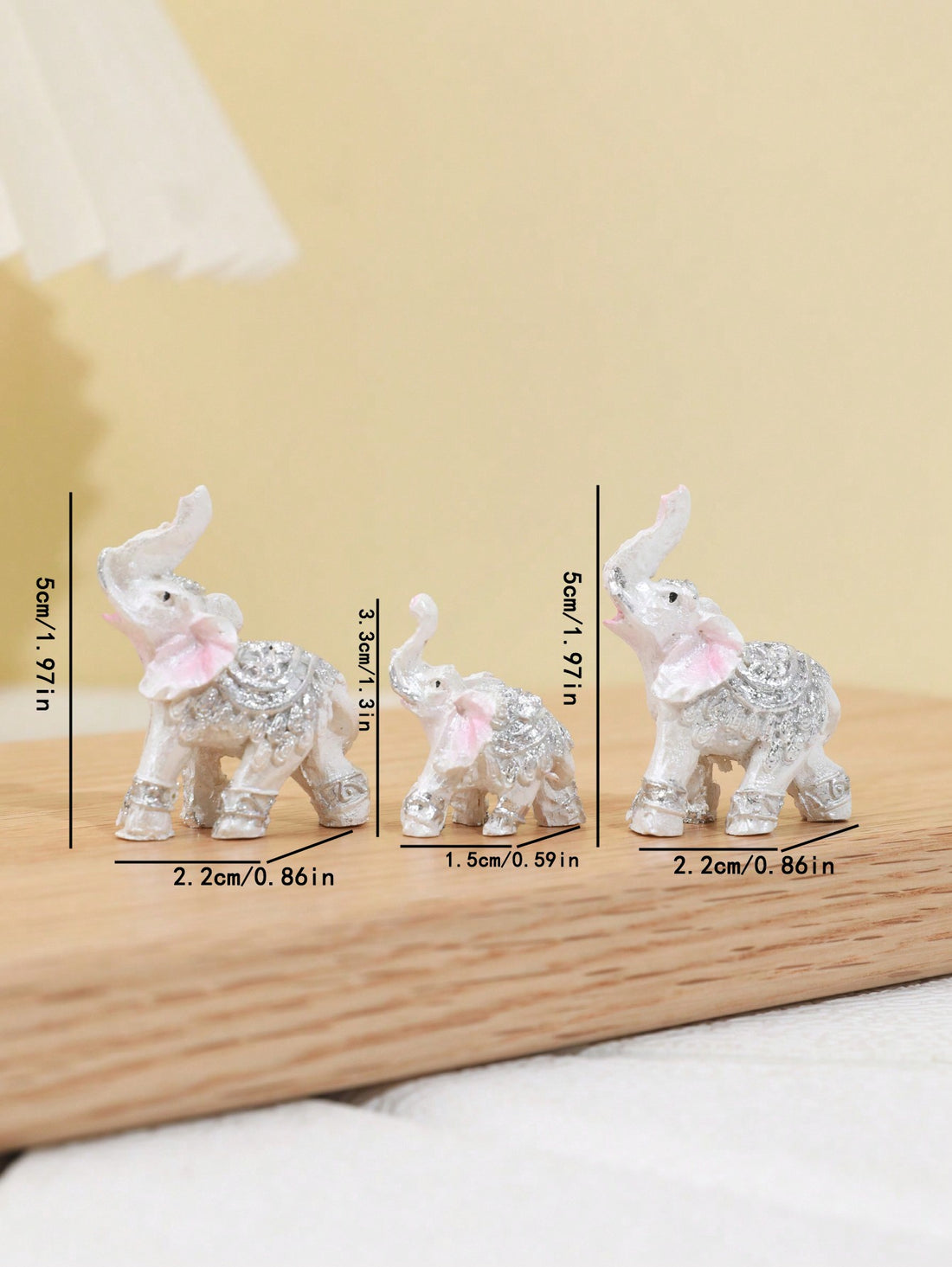 This Elegant Elephant Trio is a stunning addition to any home decor. Made of high-quality resin, these intricately crafted elephant figurines are a symbol of love and family. Perfect as table ornaments, these elegant elephants will add a touch of sophistication to your living space.