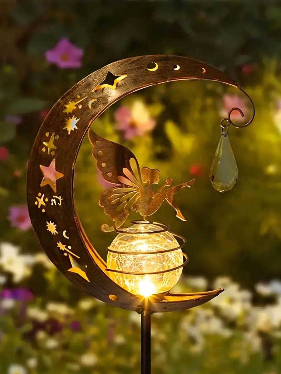 Solar crescent moon garden stake light with fairy star cutouts hanging crystal and warm crackle glass globe among plants