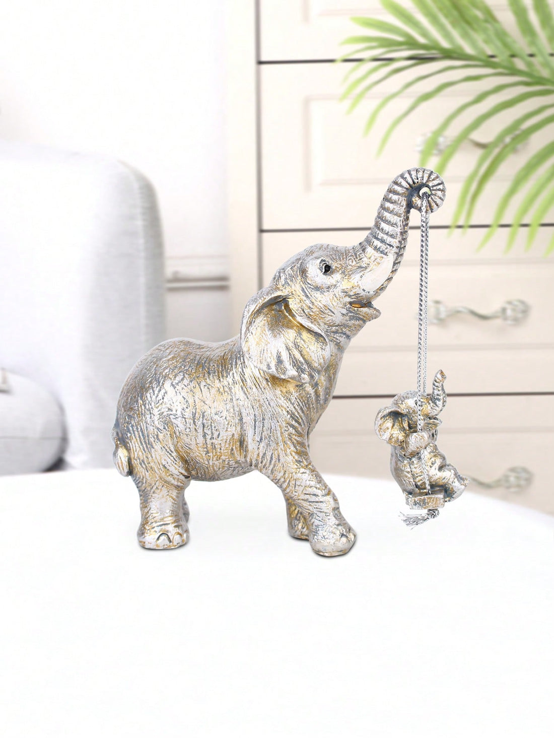 Elevate your home decor with our Mother and Child Elephant Swinging Ornament. This beautifully crafted art piece features a mother and child elephant swinging together, symbolizing the bond between mother and child. Made with high-quality materials, it adds a touch of elegance and warmth to any room.