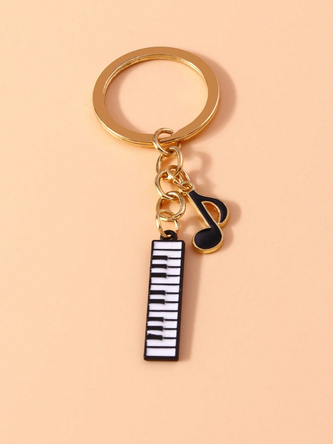 Add a melodic touch to your keys with the Melodic Charm keychain. This music-themed keychain features a piano design and a musical note pendant, perfect for music lovers and pianists alike. Show off your love for music and keep your keys organized with this unique and creative keychain.