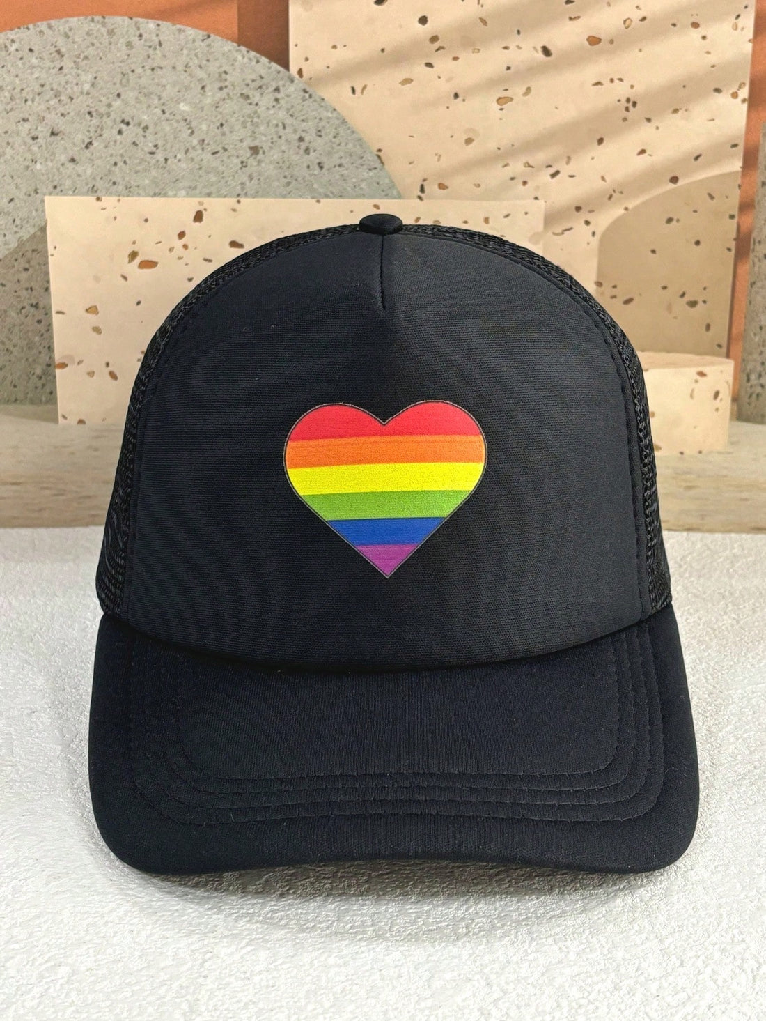 This adjustable Rainbow Heart Pride Day Trucker Hat offers sunscreen protection and breathable foam mesh for added comfort. Show your pride and keep cool with this stylish and functional cap.