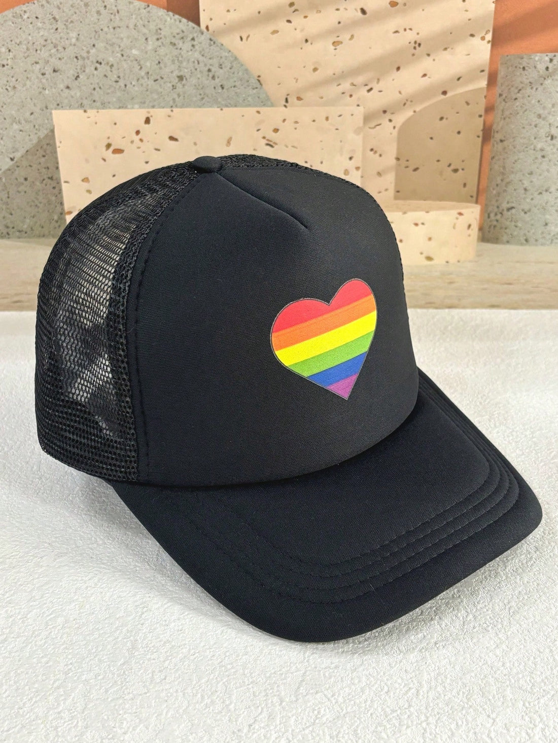 This adjustable Rainbow Heart Pride Day Trucker Hat offers sunscreen protection and breathable foam mesh for added comfort. Show your pride and keep cool with this stylish and functional cap.