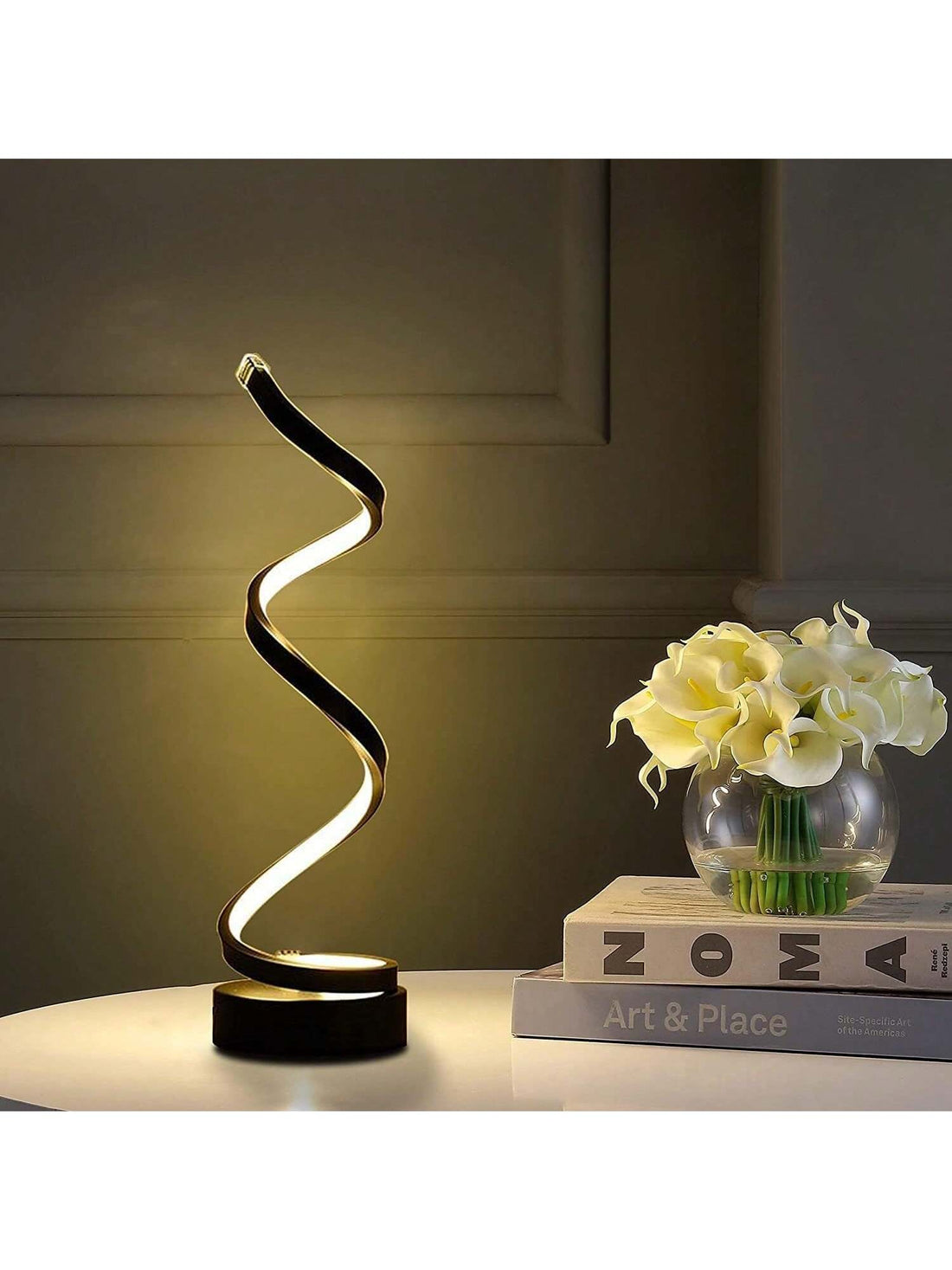 Illuminate your space with the Spiral Glow LED Table Lamp. Its modern, dimmable design makes it perfect for any bedroom, living room, or office. With adjustable brightness and a sleek spiral shape, this lamp offers both style and function. Enhance your space with energy-efficient lighting.