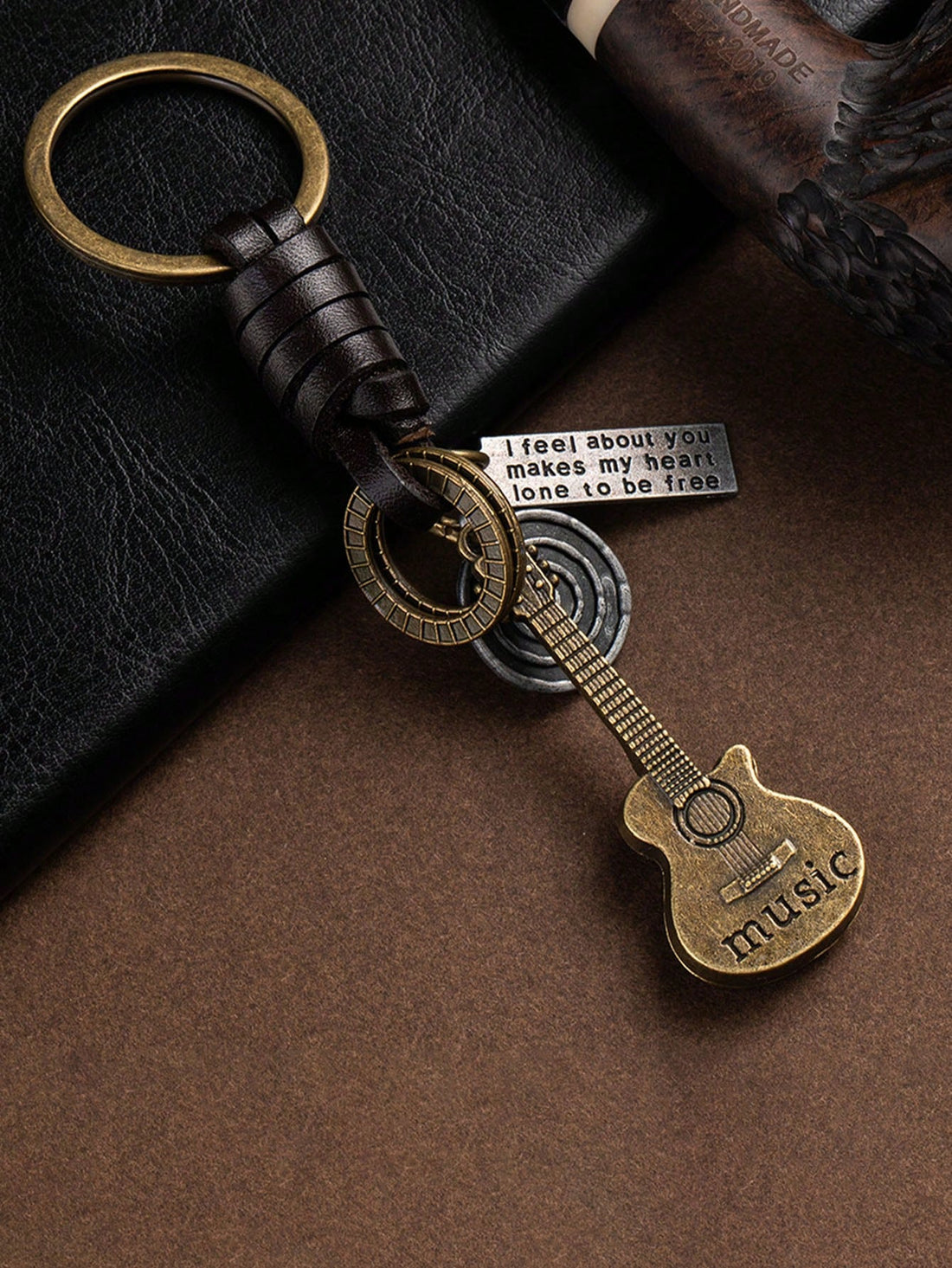 Add a touch of vintage charm to your keys with our Retro Guitar Cowhide Keychain. Handcrafted with stylish braided details, this keychain is perfect for any music lover. Made with durable cowhide for long-lasting use. Upgrade your key game today!