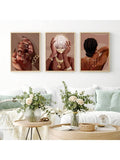 Gold framed 3pc Afrocentric wall art over sofa in bright living room