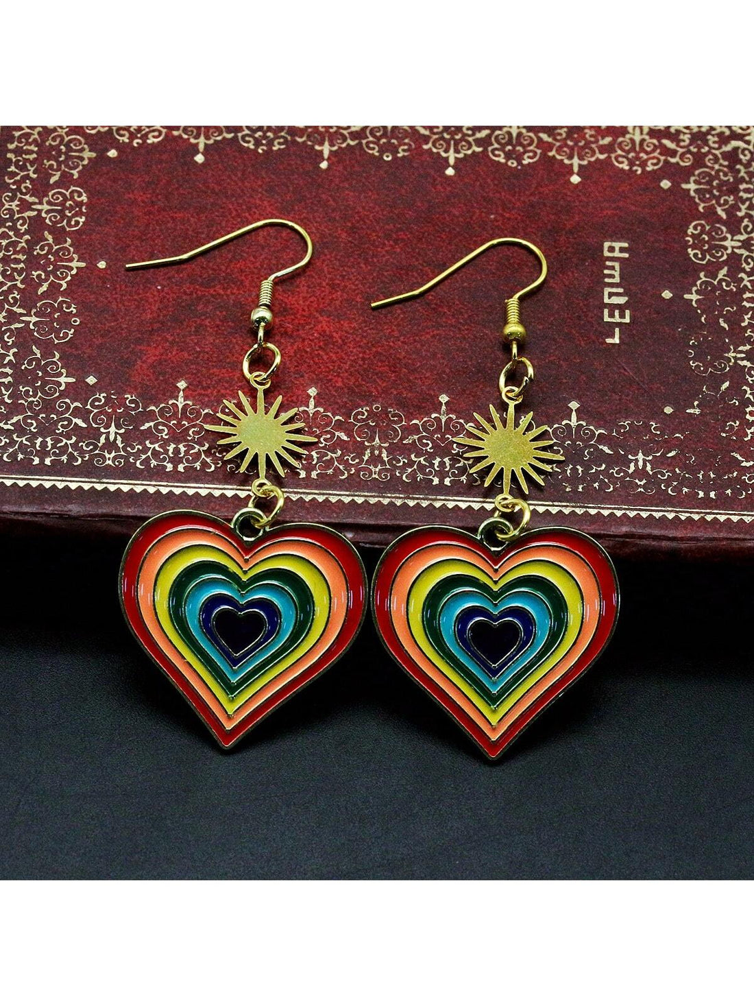 These Rainbow Heart Pride Earrings celebrate LGBTQ love with colorful enamel pendants and dangle hooks. Embrace individuality and show support for the community with this symbolic accessory. Perfect for both casual and formal wear, these earrings make a statement of love and acceptance.