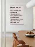 White framed Before You Go affirmation poster above a contemporary dining table