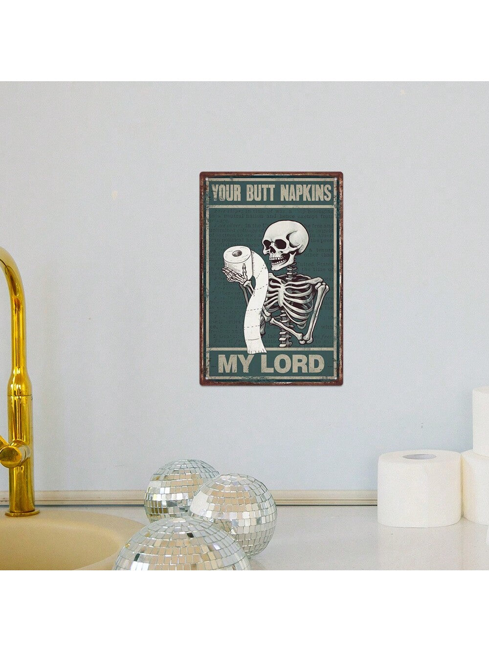 Add a touch of vintage charm to your home bathroom decor with the Butt Napkins My Lord: Vintage Skeleton Metal Tin Sign. Made of durable metal, this sign features a skeleton design and humorous phrase. Perfect for adding a unique and playful touch to your bathroom.