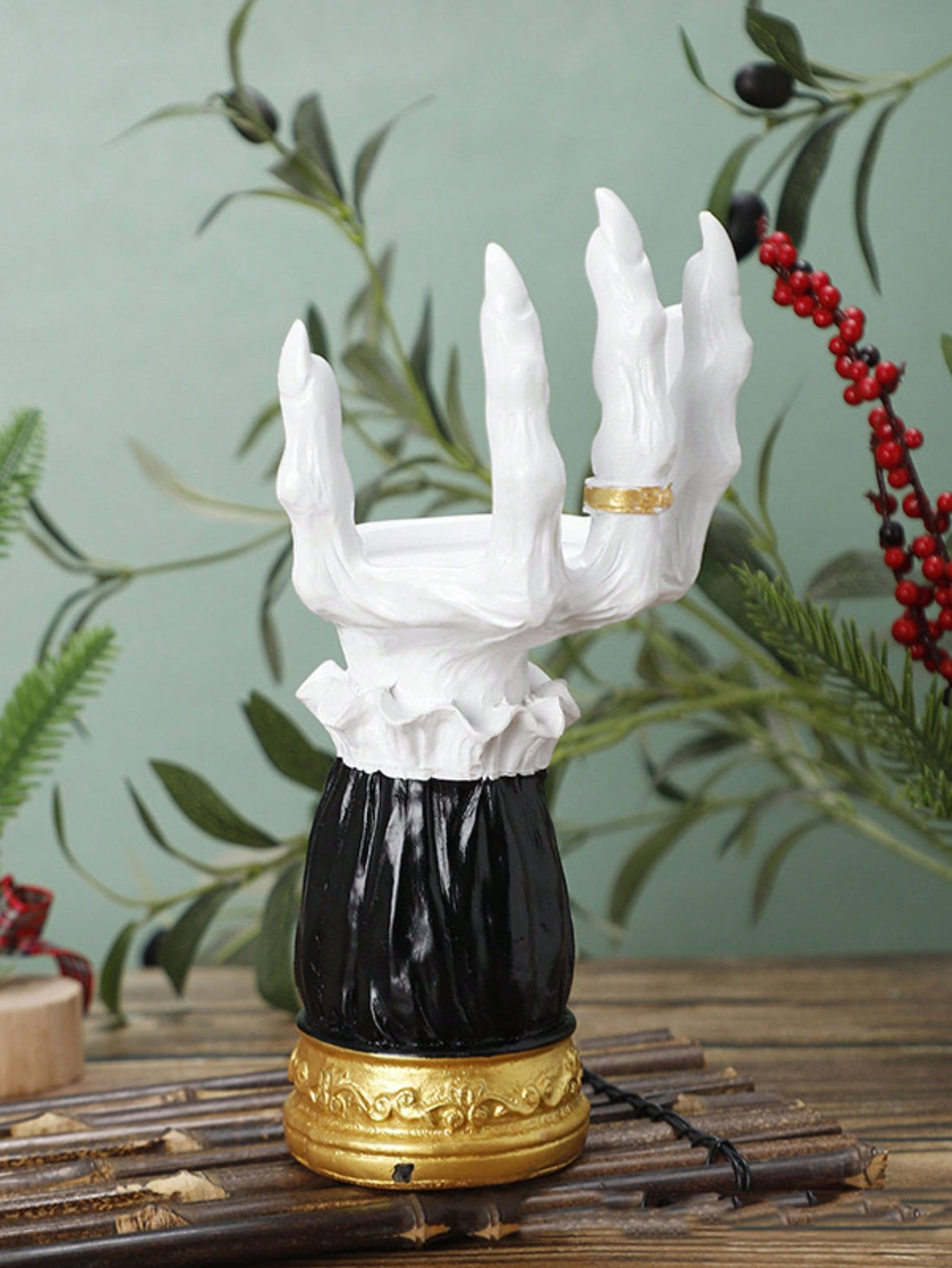 This Fright Night Candle Holder: Spooky Halloween Hand Ornament is the perfect addition to your Halloween decor. The intricately designed hand ornament adds a spooky touch to any room and holds your candles securely. Made with durable materials, it will last for many Halloween seasons to come.