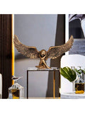 Wing shaped decorative accent displayed on books and tabletop.