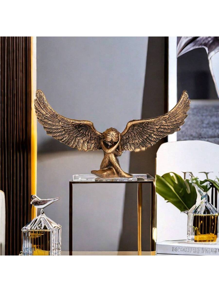 Wing shaped decorative accent displayed on books and tabletop.