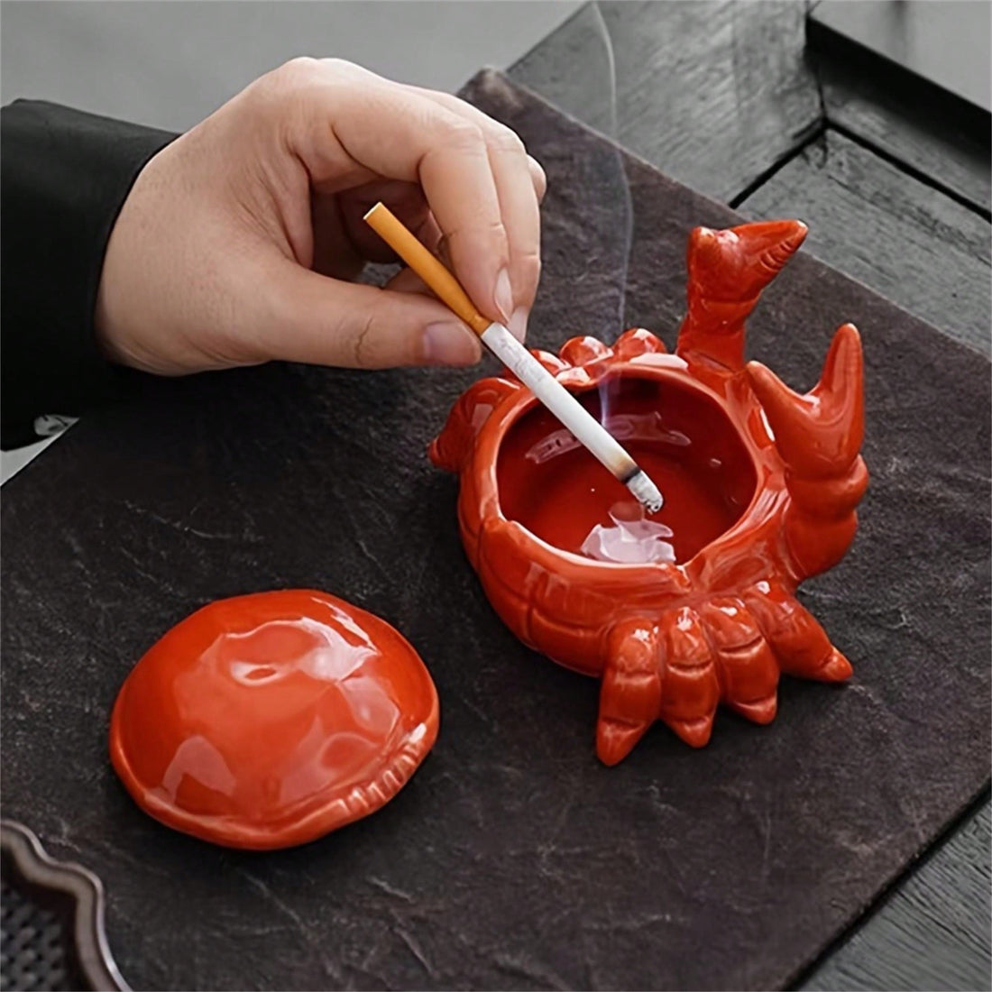 Enhance your desk decor with our Charming Crab Ceramic Ashtray with Lid - perfect for both home and office use. This adorable Chinese-style ashtray features a lid to contain odors and keep your space smelling fresh. Made with high-quality ceramic, this ashtray is not only charming but also durable for long-term use.