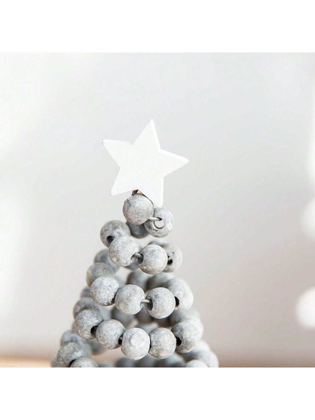 Add a charming touch to your holiday decor with our Wooden Bead Christmas Tree Ornament. Made with festive charm and an elegant design, this ornament is perfect for adorning your tabletop. Crafted with high-quality wooden beads, it adds a warm and whimsical touch to your Christmas celebrations.