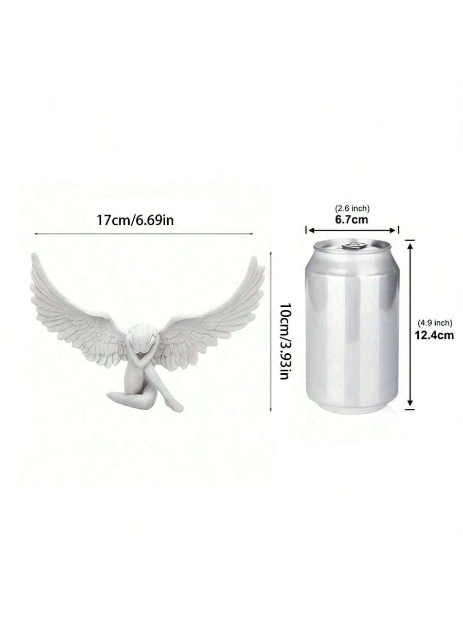 Soda can comparison showing scale of wing shaped craft ornament.