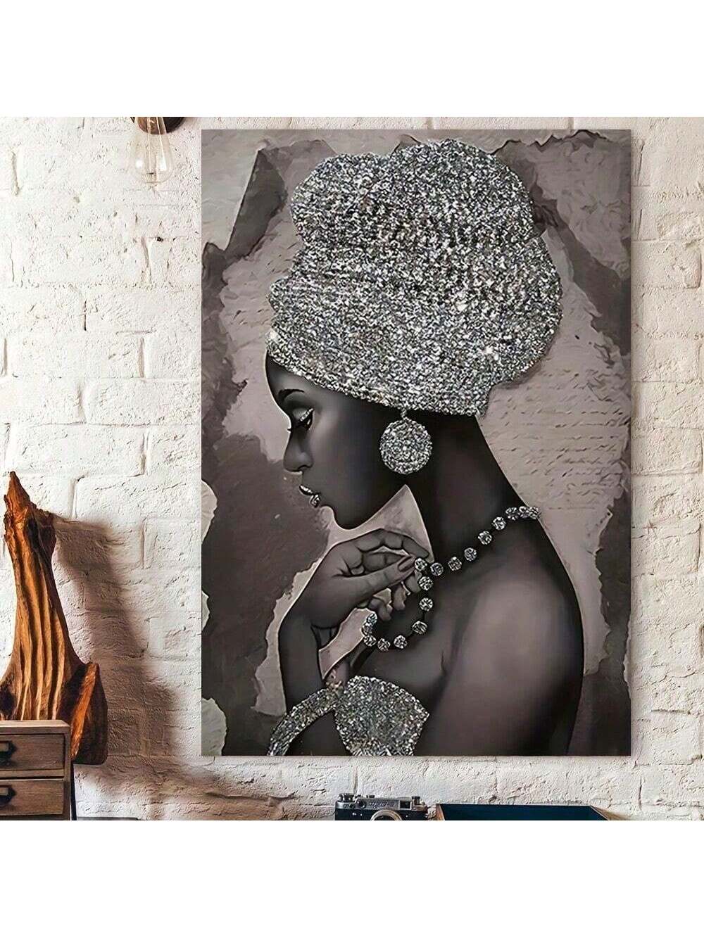 Featuring a stunning silver African woman, this framed abstract canvas painting is the perfect addition to any home wall decor. With its unique and eye-catching design, this piece is sure to add a touch of elegance and culture to any room. Made with high-quality materials, it is built to last and impress.