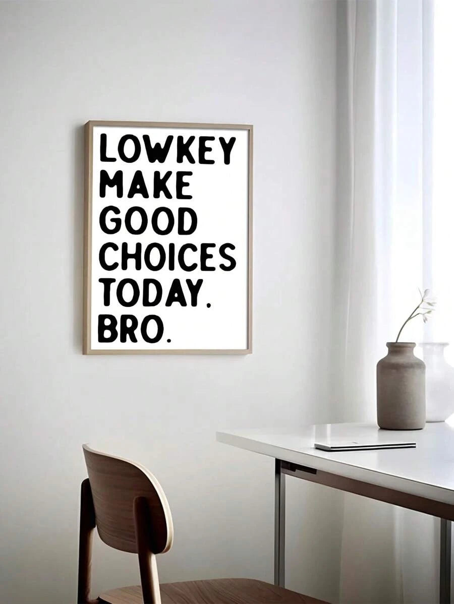 Light wood framed Make Good Choices typography print above a minimalist desk