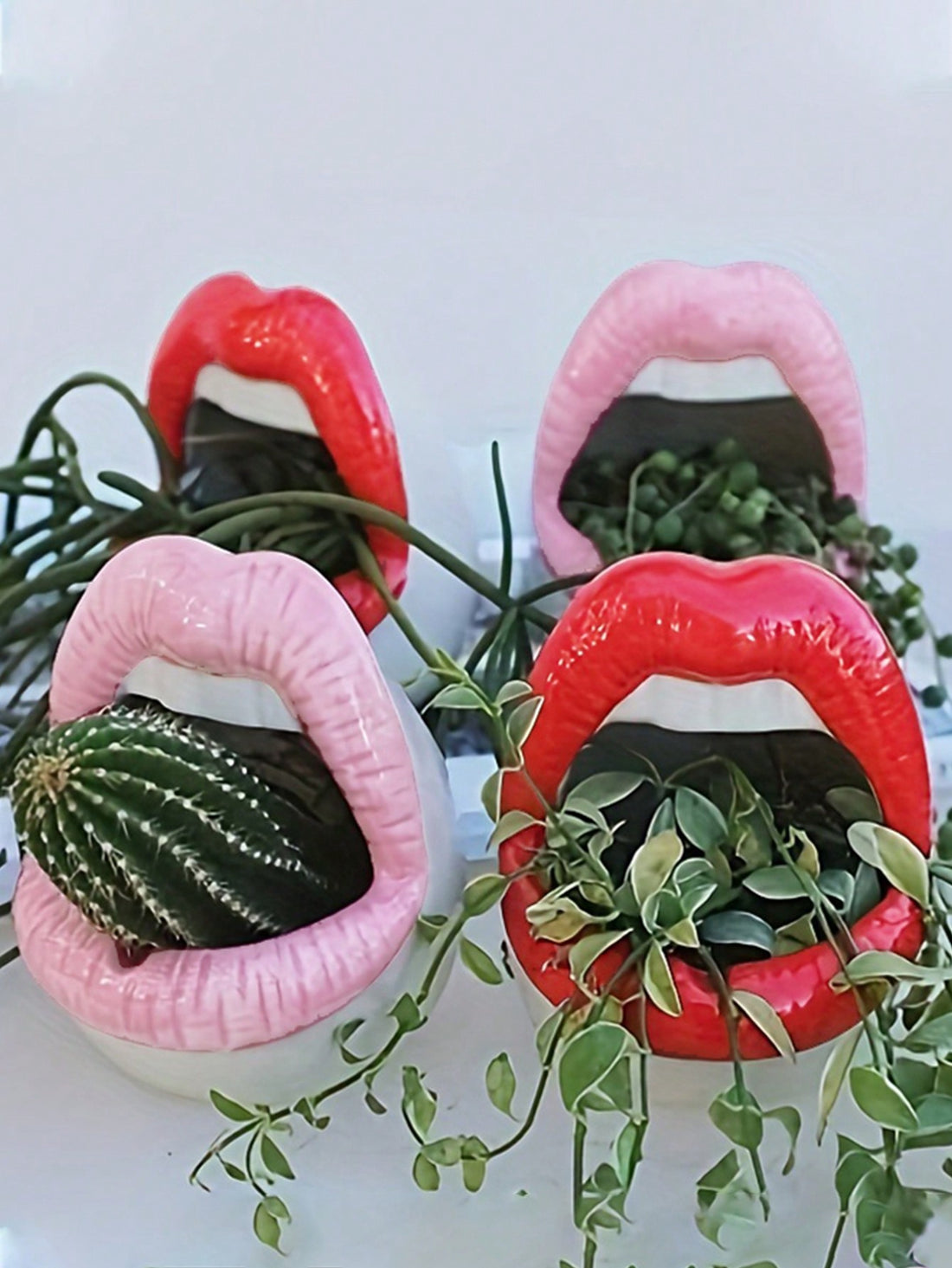 Introducing the Chic Red Lips Planter - the perfect combination of fun and functionality! Crafted with creative storage in mind, this planter is perfect for adding a pop of color to any room while keeping your space organized. Expertly designed for home and office use, make a statement with the Chic Red Lips Planter.