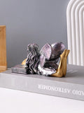 Two book-themed angel ornament variants shown together on tabletop.
