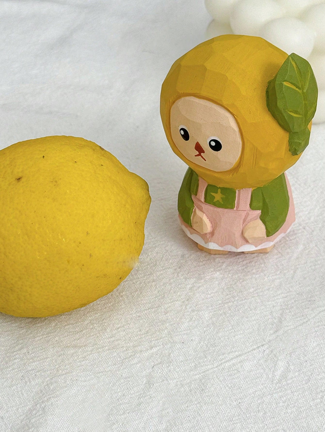 This charming handmade wooden lemon sculpture is the perfect whimsical addition to any desktop, making it a delightful home decor piece or unique gift. Crafted with expert precision, the intricate details and vibrant colors bring this lemon to life, adding a touch of playfulness to any space.