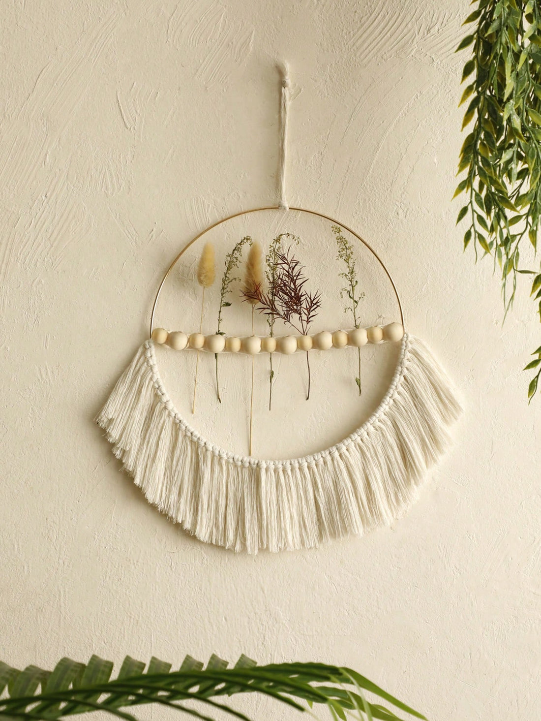 This bohemian wood bead fringe wall pendant is a chic and decorative accent for any home or bedroom. Its unique design adds a touch of style to any room, making it a perfect statement piece. Handcrafted with quality materials, this pendant is sure to elevate the aesthetics of any space.