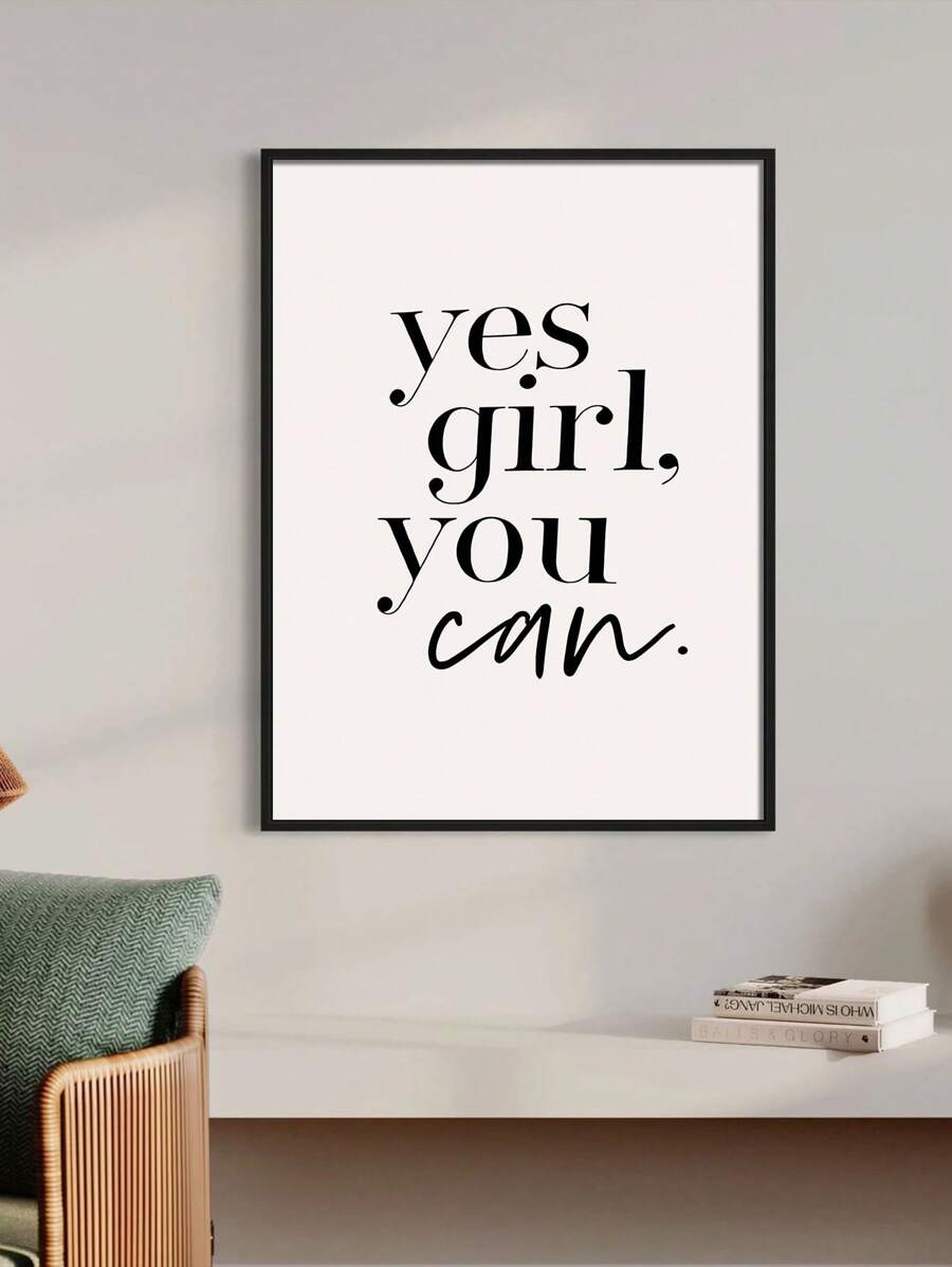 Black framed Yes Girl You Can typography art above a console and woven chair